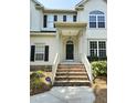 Inviting front entrance featuring brick steps, a covered porch, and a classic black front door at 1039 Bellenden Dr, Durham, NC 27713