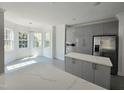 Bright kitchen featuring modern cabinets, stainless steel appliances, and an adjacent sunlit breakfast nook at 1039 Bellenden Dr, Durham, NC 27713