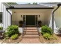 Inviting front entrance with brick steps, black iron railing, and a double door entry way, adding curb appeal at 10817 Brass Kettle Rd, Raleigh, NC 27614