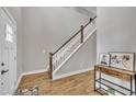 Inviting foyer features wood flooring, a staircase with white risers, and a decorative console table at 1109 Agio Ct, Zebulon, NC 27597