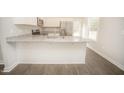 Modern kitchen features a breakfast bar, granite countertops, and stainless steel appliances at 112 Ambergate Ct, Rocky Mount, NC 27804