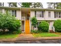 Charming townhouse with a wooden staircase leading to the entrance and lush landscaping at 121 Westview Dr # 22, Carrboro, NC 27510