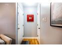 Inviting hallway with hardwood floors, a red mirror, and multiple doorways at 121 Westview Dr # 22, Carrboro, NC 27510