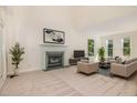 Inviting living room featuring a fireplace, plush seating, and abundant natural light at 122 N Fern Abbey Ln, Cary, NC 27518