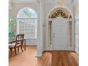 Bright foyer with hardwood floors, large windows, and a view of the dining area at 1224 Wedgeland Dr, Raleigh, NC 27615