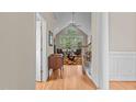 Open-concept living room with vaulted ceilings, large windows, and a colorful rug at 1224 Wedgeland Dr, Raleigh, NC 27615