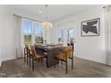 Bright dining room with table set for six, modern chandelier, and large window with lots of natural light at 135 Harmony Ranch Lane, Franklinton, NC 27525