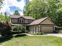 Charming two-story home with a landscaped front yard and attached two-car garage, surrounded by lush trees at 1514 John Jones Rd, Bahama, NC 27503