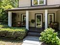 Inviting front porch with seating and lush greenery, offering a welcoming entrance to the home at 1514 John Jones Rd, Bahama, NC 27503