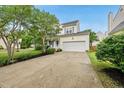 Exterior view of a home with an attached two-car garage and spacious driveway at 1605 Old London Way, Apex, NC 27523