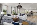 Open-concept living room with lots of natural light, recessed lighting, and stylish decor at 168 Copperleaf Court, Franklinton, NC 27525