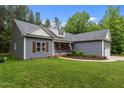 Charming one story home featuring a two-car garage, landscaped front yard, and inviting curb appeal at 1850 Willie Pace Rd, Burlington, NC 27217
