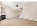 Spacious living room with neutral carpet, fireplace, and staircase at 2111 Piney Brook Rd # 101, Raleigh, NC 27614