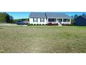 Charming single-story home with a welcoming front porch and well-maintained lawn at 212 Placid Pond Dr, Broadway, NC 27505