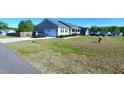 Well-kept home with an attached garage, long driveway and manicured lawn at 212 Placid Pond Dr, Broadway, NC 27505