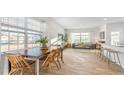Open-concept living area with dining space, stylish furnishings, and large windows at 239 Moyer Dr, Graham, NC 27253