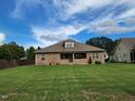 Wide view of the backyard showing lawn space and the exterior of the home at 243 Nortwick Rd, Rolesville, NC 27571
