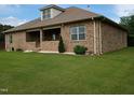 Brick home with a covered patio and well maintained lawn with white gravel at 243 Nortwick Rd, Rolesville, NC 27571