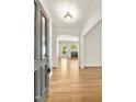 Inviting foyer with hardwood floors, arched doorway, and ample natural light flowing into the adjacent living spaces at 2819 Ellis Chapel Rd, Bahama, NC 27503