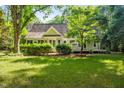 This lovely home features beautiful landscaping, mature trees, and views of the surrounding greenery in the backyard at 2819 Ellis Chapel Rd, Bahama, NC 27503