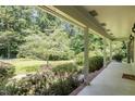 Scenic porch view overlooking a lush green lawn and mature trees, creating a serene outdoor space at 3125 Stanford Dr, Durham, NC 27707