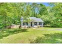 Charming single-story home with a well-maintained lawn, mature trees, and a cozy, inviting facade at 324 Waterside Dr, Sanford, NC 27330