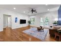 Spacious living room featuring hardwood floors, ceiling fan, and a view of the backyard at 3359 Denise St, Durham, NC 27704