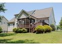 Spacious backyard featuring a screened porch, wooden deck, and lush green lawn perfect for outdoor enjoyment at 337 Shadowdale Ln, Rolesville, NC 27571