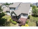 An elevated view showcases a deck, screened porch, and fenced yard, surrounded by lush greenery at 337 Shadowdale Ln, Rolesville, NC 27571