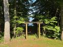 Beautiful wooded backyard view of the lake through a lovely wooden pergola at 3750 Mebane Rogers Rd, Mebane, NC 27302