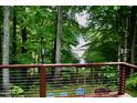 Secluded backyard deck featuring a relaxing seating area with a beautiful view of the lake at 3750 Mebane Rogers Rd, Mebane, NC 27302