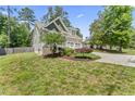 Beautiful home with a lush green lawn and mature trees in a serene neighborhood setting at 3914 Old Chapel Hill Rd, Durham, NC 27707