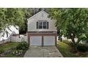 Charming two-story home featuring a two-car garage, brick accents, and well-manicured landscaping at 4216 Lake Woodard Dr, Raleigh, NC 27604