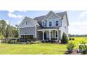 Inviting two-story home with gray siding, classic white trim, and a welcoming front porch at 456 Golden Dragonfly St, Wake Forest, NC 27587