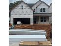 New construction shows the exterior of a house under construction with a garage and covered front porch at 456 Golden Dragonfly St, Wake Forest, NC 27587