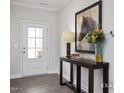 Inviting foyer with a decorative table, flowers, and a horse picture that enhances its style at 456 Golden Dragonfly St, Wake Forest, NC 27587