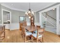 Traditional dining room with hardwood floors, chandelier, and direct access to the grand foyer at 4817 Fox Branch Ct, Raleigh, NC 27614
