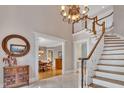 Grand foyer featuring a staircase, tile floors, chandelier, and views into the dining room at 4817 Fox Branch Ct, Raleigh, NC 27614