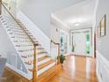 Inviting foyer with hardwood floors, staircase, and natural light from the front door at 5720 Brushy Meadows Dr, Fuquay Varina, NC 27526