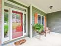 Cozy front porch with a welcome mat, bench, and a lush green fern at 5720 Brushy Meadows Dr, Fuquay Varina, NC 27526