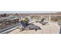 Rooftop terrace with lounge chairs offering stunning city views, perfect for relaxing and enjoying the outdoors at 601 W Rosemary St # 712, Chapel Hill, NC 27516