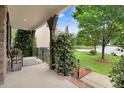 Charming covered front porch with beautiful landscaping and classic architectural details at 62 Jubilee Ct, Clayton, NC 27527