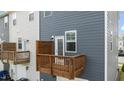 View of private backyard balcony with wood railing and neutral-colored siding at 6352 Perry Creek Rd, Raleigh, NC 27616