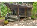 Charming front porch with dark wooden railings and stairs, perfect for relaxing outdoors at 6412 Heartwood Dr, Chapel Hill, NC 27516
