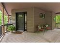 Cozy front porch features chairs, a small table and a welcome mat for guests at 6412 Heartwood Dr, Chapel Hill, NC 27516