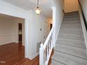 Bright foyer with staircase and hardwood flooring, offering a welcoming entrance at 6756 Olde Province Ct, Raleigh, NC 27609