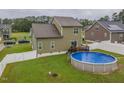 Spacious backyard featuring a well-maintained lawn, privacy fence, and above-ground swimming pool at 71 Sandy Farm Ct, Willow Springs, NC 27592