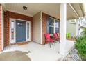 Inviting front porch featuring a seating area, charming details, and a welcoming entrance at 7584 Oakberry Dr, Raleigh, NC 27616