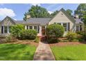 Charming single-story home with manicured lawn and a welcoming front porch and mature landscaping at 800 E Forest Hills Blvd, Durham, NC 27707