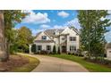 A beautiful two-story home featuring manicured lawn, professional landscaping and stone and shingle facade at 8709 Kimalden Ct, Wake Forest, NC 27587